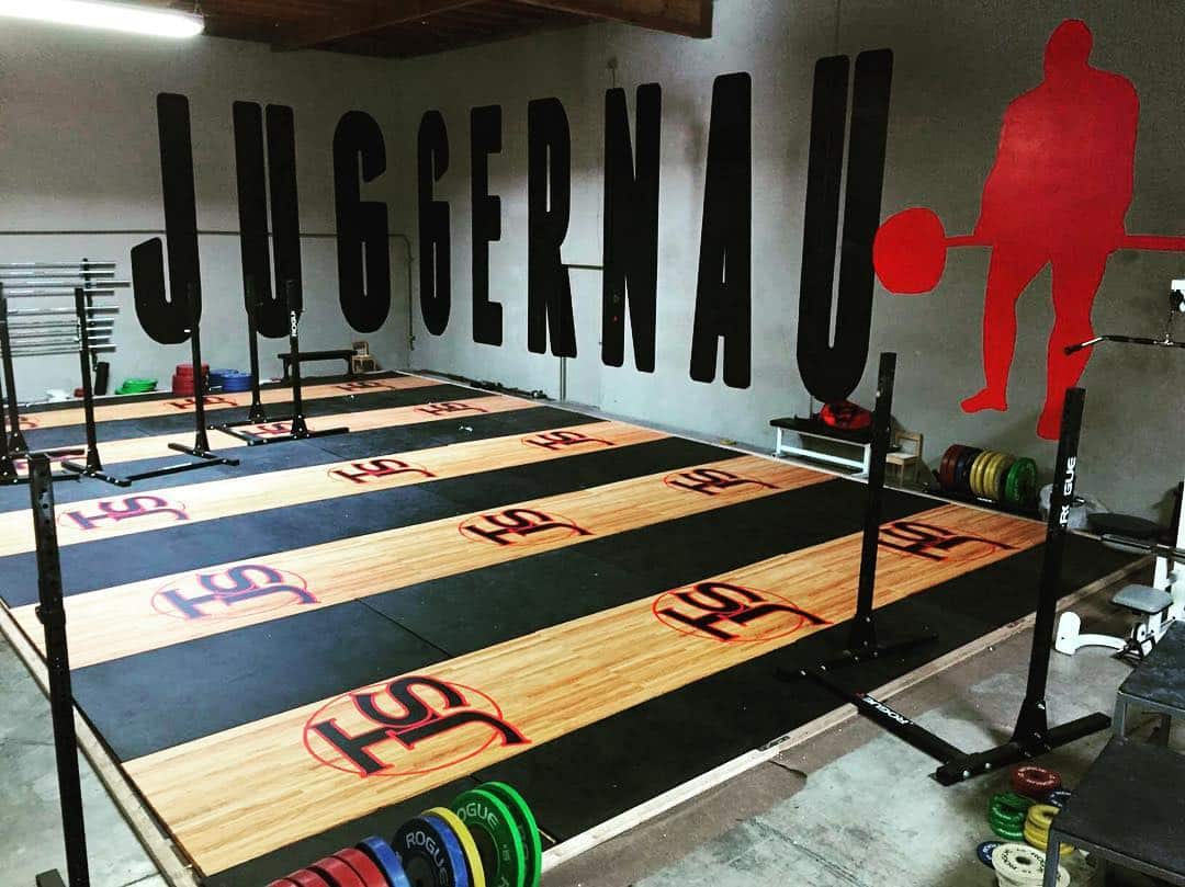 Wall signage displayed at a fitness event with customized gym branding