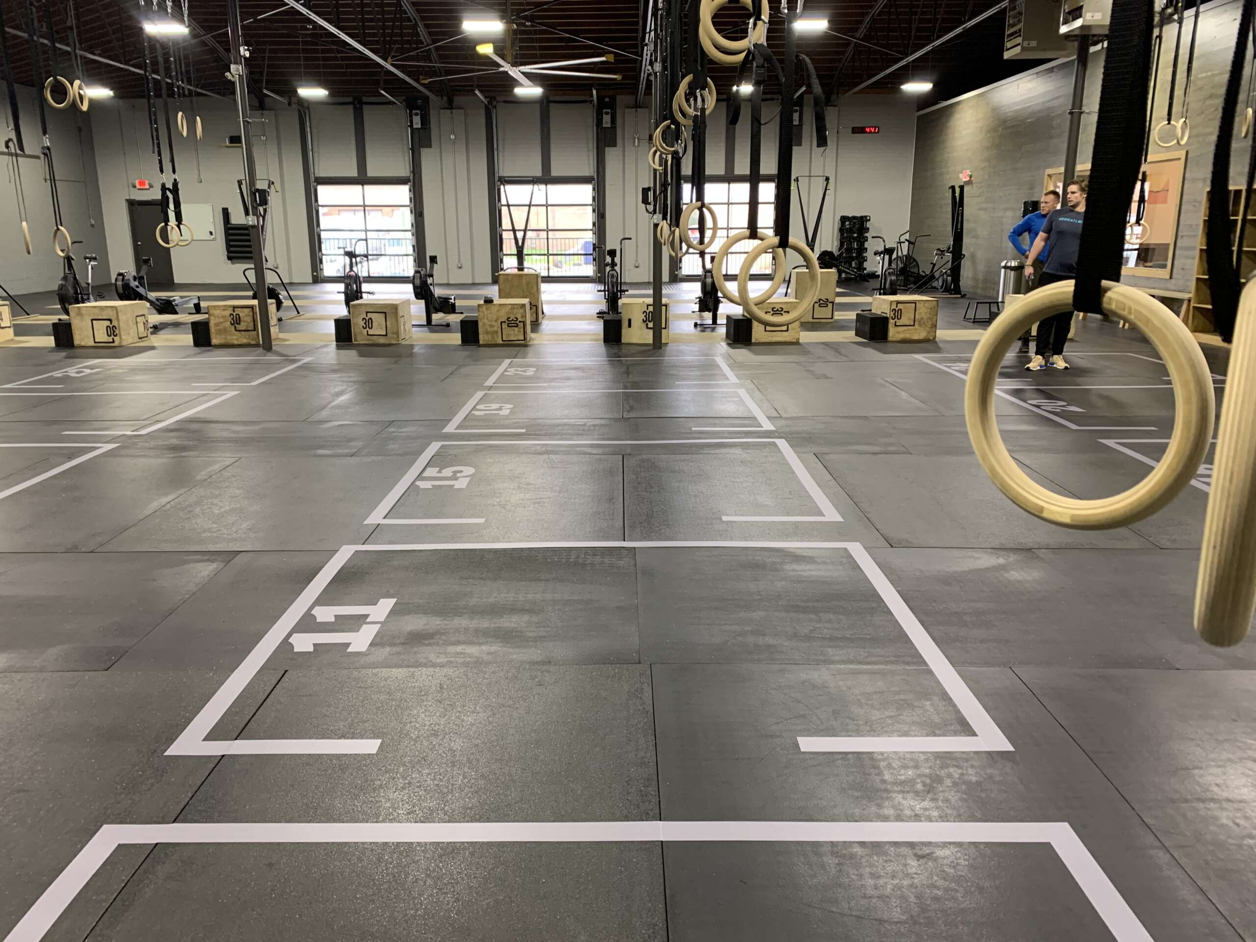 Floor grid decals for fitness centers, safety-focused and scrubber-resistant vinyl.