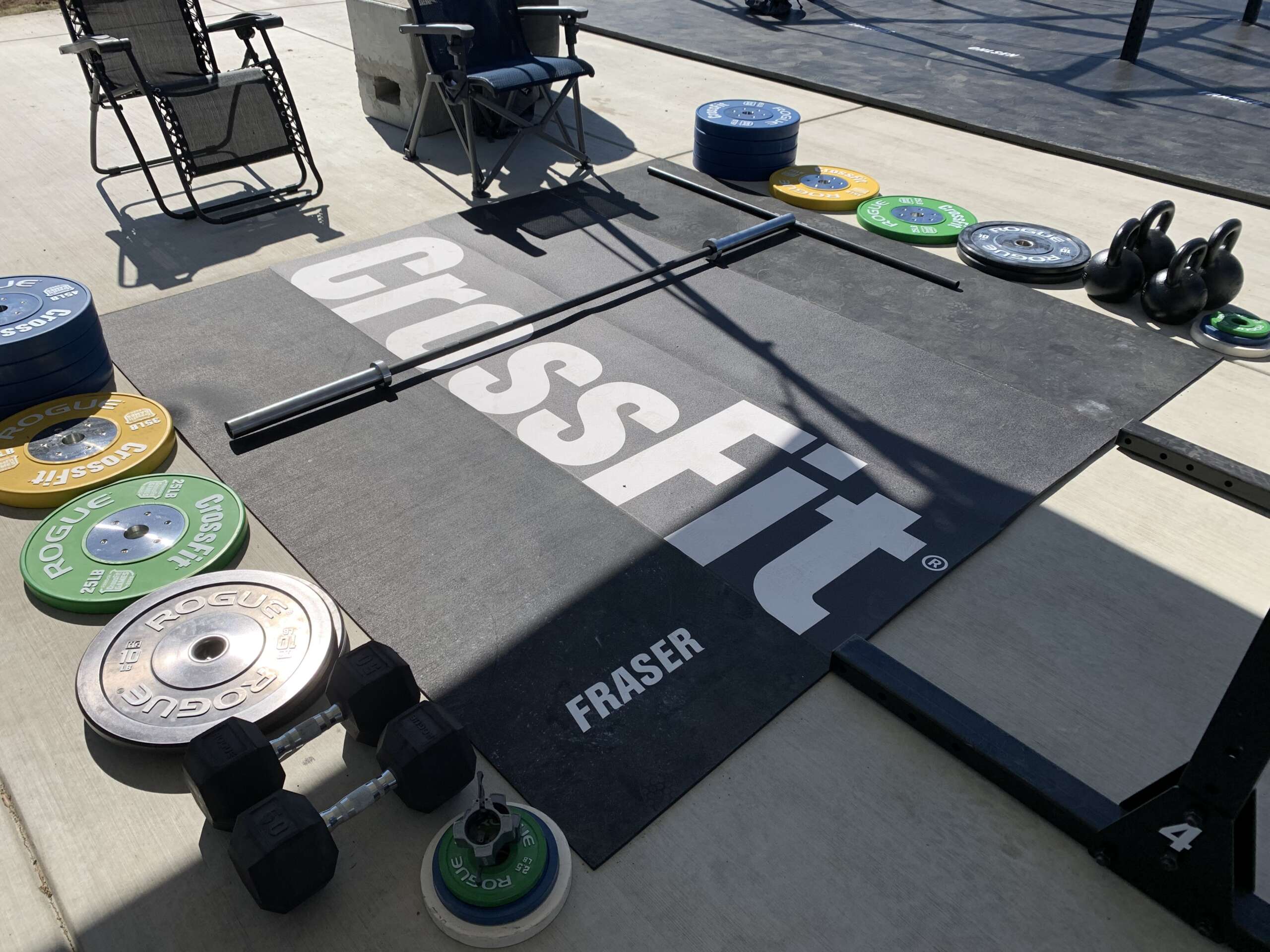 High-resolution gym event photo with athletes and branded signage on the competition floor