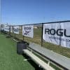 Event signage banner mounted on metal barricade