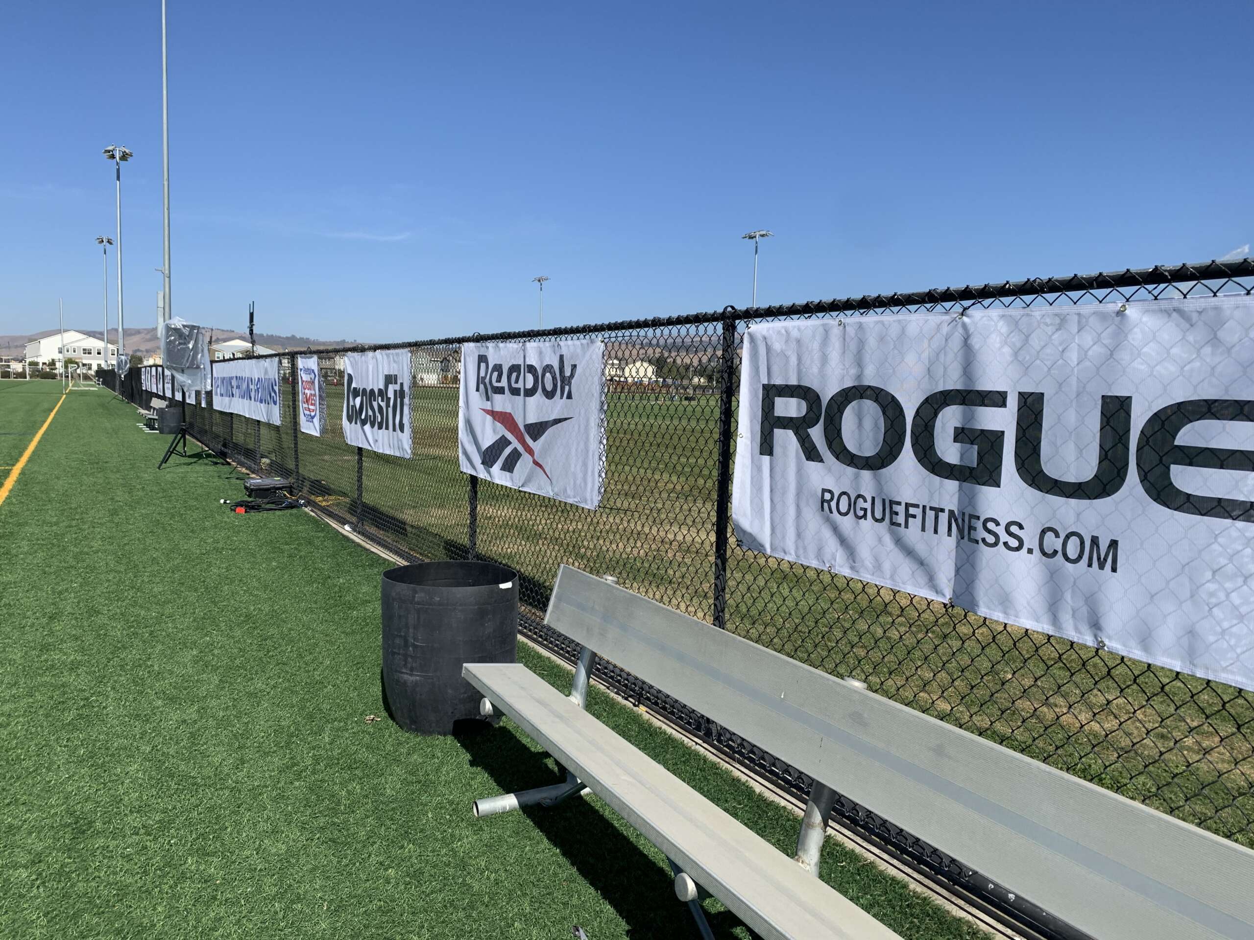 Event signage banner mounted on metal barricade