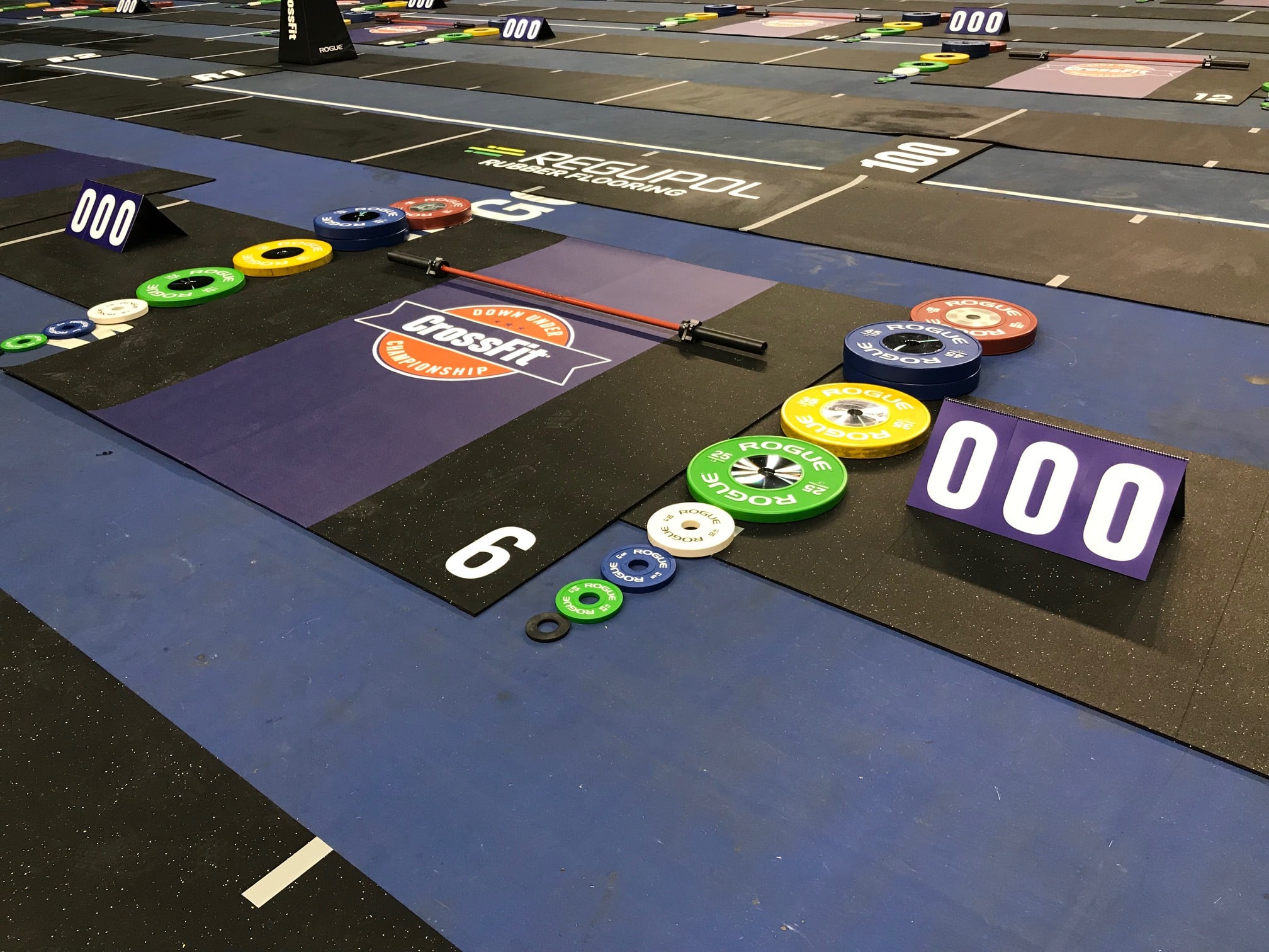 Gym interior with wall graphics and athlete nameplates during a live event