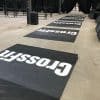 Indoor gym event setup with full wall signage and branded podiums