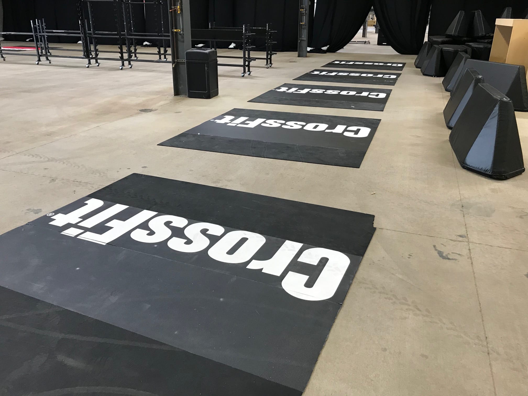 Indoor gym event setup with full wall signage and branded podiums